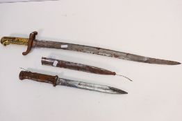 Two bayonets comprising a French M1842 sabre bayonet with 57 cm (l) blade and brass hilt,