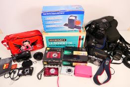 A collection of cameras, camcorders and a slide projector.