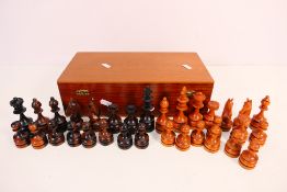 A carved wood chess set with 10 cm (h) king.