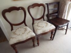 A pair of Victorian balloon back chairs with upholstered seats and tapered supports,