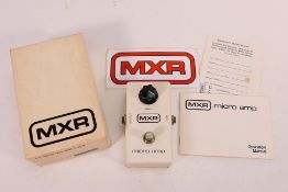 A boxed MXR Micro-Amp guitar pedal.
