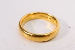 A 22ct gold wedding band, size P+½, approximately 10 grams.