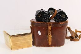 A cased pair of Ross 9x35 Stepruva binoculars numbered 131491 and a Gold Filled cigarette case.