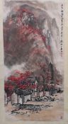 An Oriental hanging scroll with landscape village scene, signed, approximately 135 cm x 53 cm.