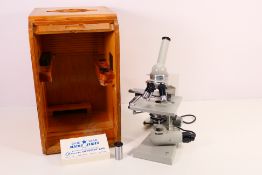 A vintage Carl Zeiss - Jena microscope contained in tambour front wooden case.