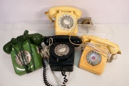 Four vintage dial telephones.