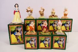 Walt Disney - A set of Royal Doulton figures, Snow White And The Seven Dwarfs, all boxed,