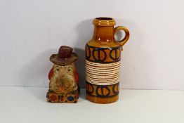 An unusual double sided ceramic bust depicting a dog wearing a hat and smoking a cigarette,