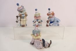 Four Lladro clown figures to include # 5279, Pierrot With Concertina, # 5812, Tired Friend, # 5278,
