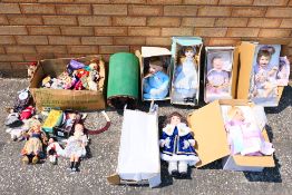 Three boxes of various dolls.
