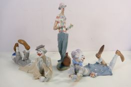 Three Lladro clown figures comprising # 6997, Clown In Love, # 4618 and # 6913, The Magic Of Comedy,