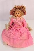 A bisque shoulder head doll with soft body and bisque lower arms and legs and striking blue glass