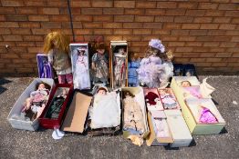 Two boxes of various dolls.
