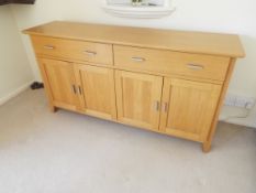 Morris Furniture Co of Glasgow - a modern light oak sideboard having twin frieze drawers over four