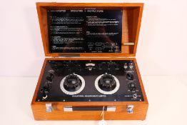 An Educational Measurements Limited Battery And Standard Cell Compartment contained in wooden case