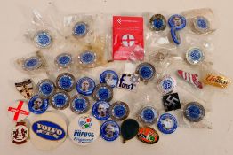 A collection of pin badges, predominantly football related.
