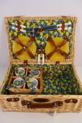 A Sherwood Hampers wicker picnic basket with contents.