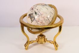 A tabletop specimen terrestrial globe, on brass tripod stand, 37 cm (h).
