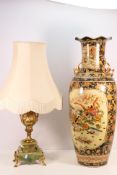 A large Japanese twin handled vase decorated with birds in a landscape setting,