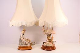 Two figural table lamps, the first with flamingos the other with a lady pushing a flower cart,