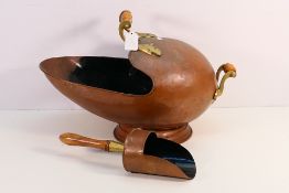 A vintage copper and brass coal scuttle.