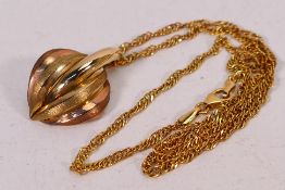 A 9ct two-tone gold pendant on yellow metal (stamped 375) rope twist necklace, 42 cm (l),