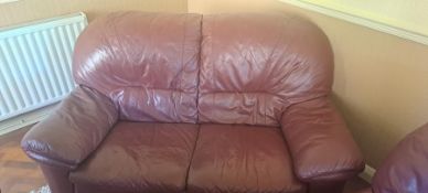A red leather three piece lounge suite comprising two two seater sofas and a single seater.