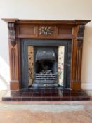 A fireplace with carved detail and cast iron tiled insert, approximately 118 cm x 137 cm.