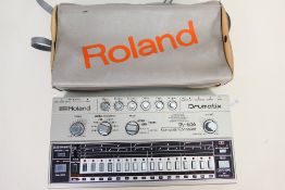 A Roland Drumatix TR-606 Computer Controlled drum machine contained in carry case.