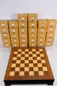 A Tudor Mint fantasy themed chess set of chess board and 32 individually boxed pieces.