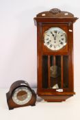 An oak cased wall clock, the dial marked Radium, with key and pendulum and a mantel clock. [2].