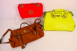 Three fashion handbags, one in a vibrant green colour.
