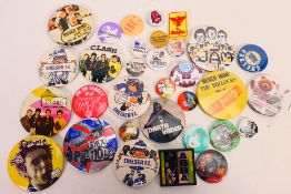 A collection of vintage pin badges, predominantly music / bands related to include The Sex Pistols,