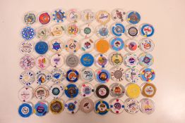In excess of sixty American casino chips, predominantly $1 denomination, all encapsulated.