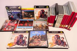 A collection of boxed Super 8 cine film reels, some in pictorial boxes, labels include Madigan,