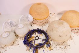 Three mottled glass ceiling lights with decorative beadwork and two matching wall lights,