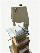 An Inca Bandsaw, attached to wooden platform with storage and wheeled trolley, bandsaw 90 cm (h),