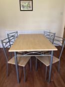 A modern light wood and silver coloured metal dining/breakfast table with four matching chairs,