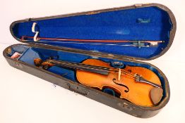 A late 19th / early 20th century violin, 55 cm (l), with paper maker's label to the interior,