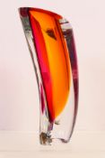 Kosta Boda - A large glass Aria vase of curved form, designed by Goran Warff, in red,