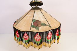A decorative Tiffany style ceiling light with rose motifs, approximately 48 cm (d).
