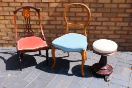 A vintage rise and fall piano stool with