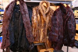Three fur jackets, one with size label 36, no makers labels,