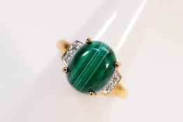 A 9ct yellow gold ring set with malachite cabochon and illusion set shoulders, size N,