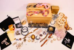 A collection of costume jewellery to include earrings, brooches, necklaces and other.
