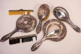 A collection of silver backed dressing table items comprising two brushes,
