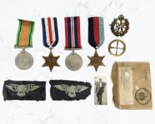 A WWII medal group including RAF cap badge, insignia, and a small photograph,