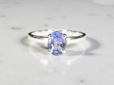 An 18ct white gold tanzanite solitaire ring, the oval-cut tanzanite weighing an estimated 0.