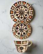 A harlequin Royal Crown Derby Imari porcelain teacup, saucer, and plate trio,