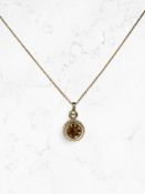 A 9ct gold citrine pendant on chain,